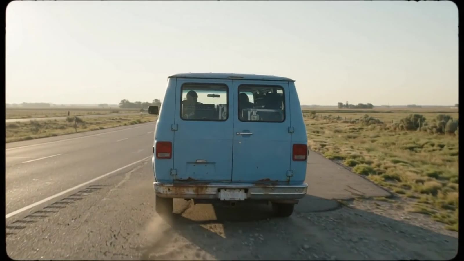 A blue van on an open highway